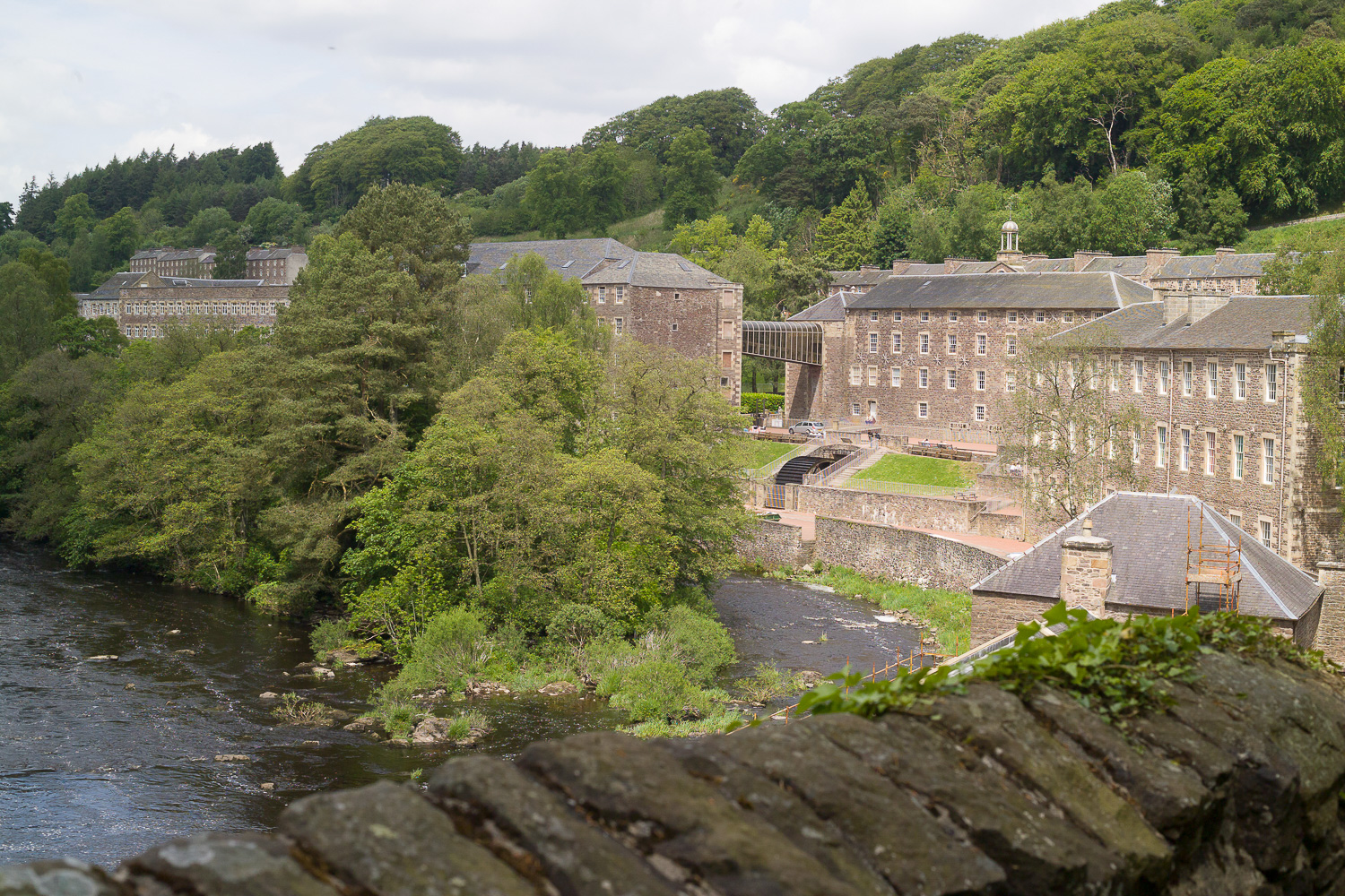 New Lanark, textiel industriegebouwen langs een rivier.